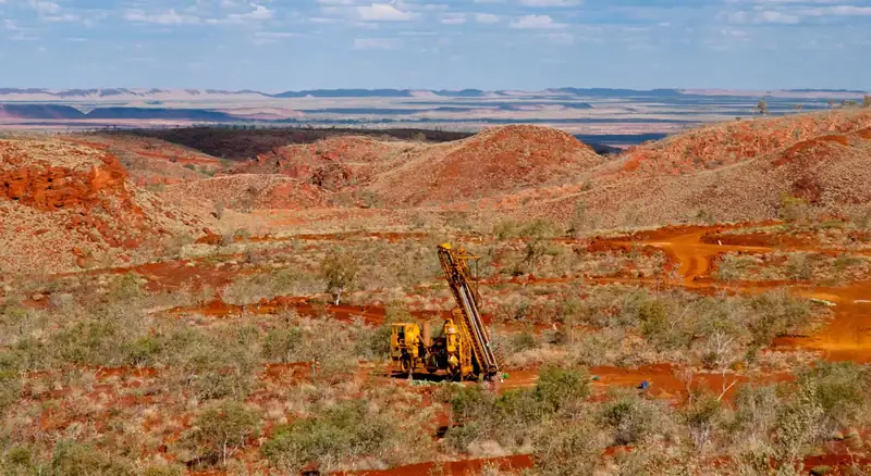 Desert landscape with mining equipment visible.